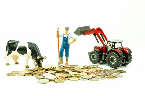 Figur von Kuh, Landwirt und Traktor auf Münzen